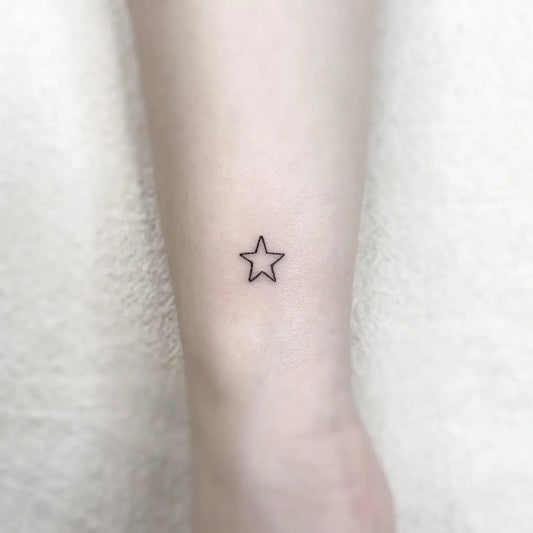 Tiny Fine Line Star Tattoo on Women Wrist by @gorae_tattoo