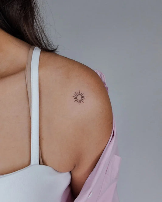 Tiny Fine Line Sun on Women Shoulder Tattoo by @okankaskaya.ink