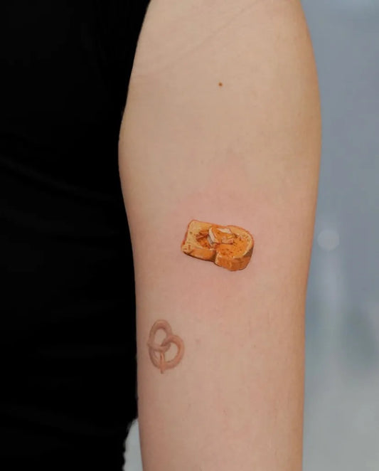 Tiny Fine Line Toast Pretzel on Women Arm Tattoo by @madgreytattoo