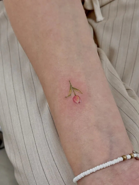 Tiny Fine Line Tulip Tattoo on Women Arm by @tattoo_thailand