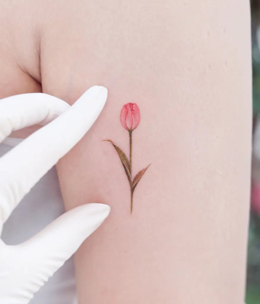Tiny Fine Line Tulip Tattoo on Women Arm by @tattooist.haneul