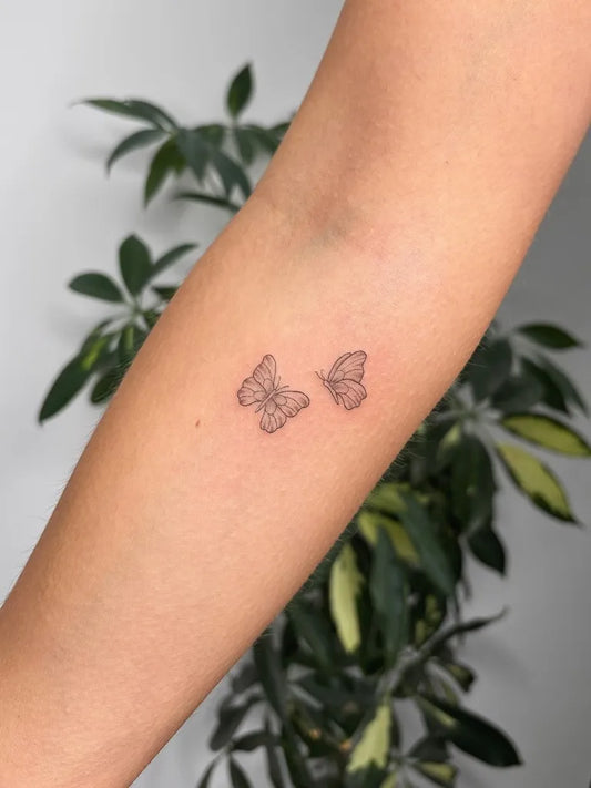 Tiny Fine Line Two Butterflies on Women Arm Tattoo by @lucyvalentinatattoo