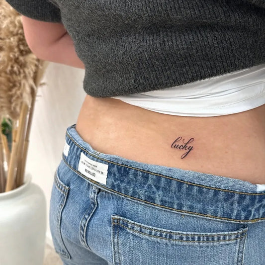 Tiny Fine Line lucky Women Lower Back Tattoo on by @inkedby.chlo