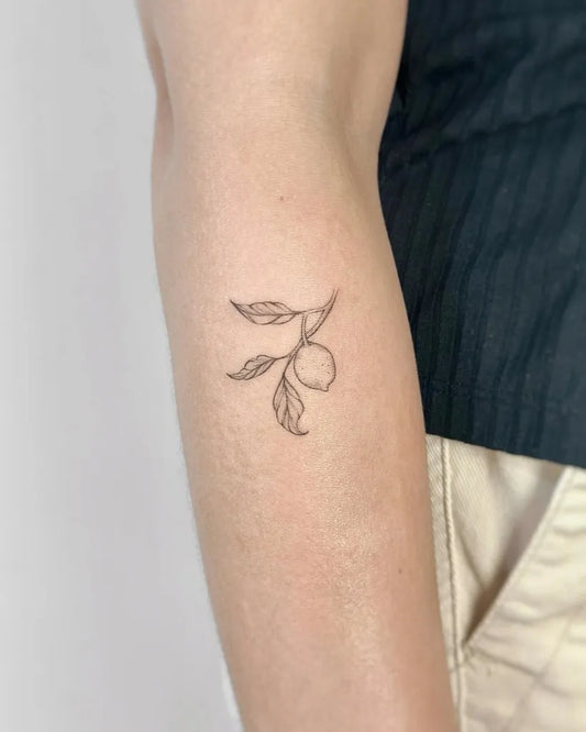 Tiny FineLine LemonLeaf on Women Arm Tattoo by @cha.tattoo