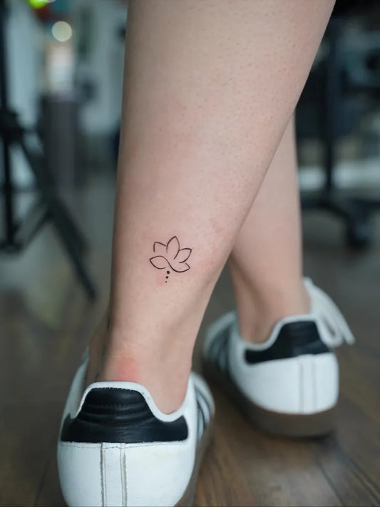 Tiny FineLine Lotus Flower on Women Ankle Tattoo by @julia.tatts