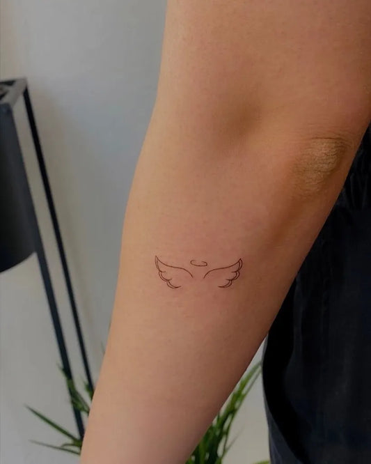 Tiny Linework Angel Wings Tattoo on Women Arm by @elenaskinart