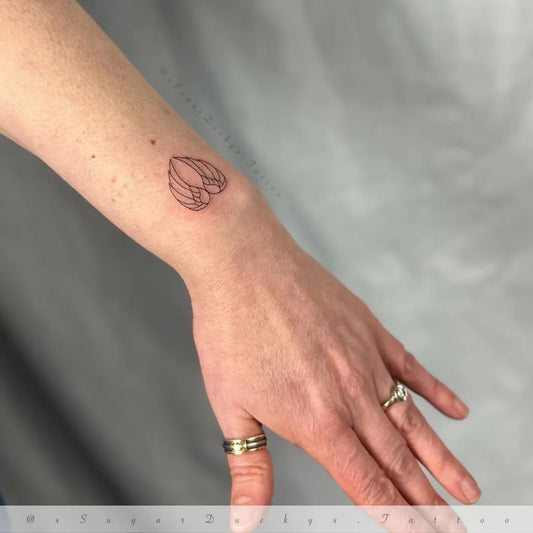 Tiny Linework Angel Wings Tattoo on Women Wrist by @xsugarduckyx.tattoo