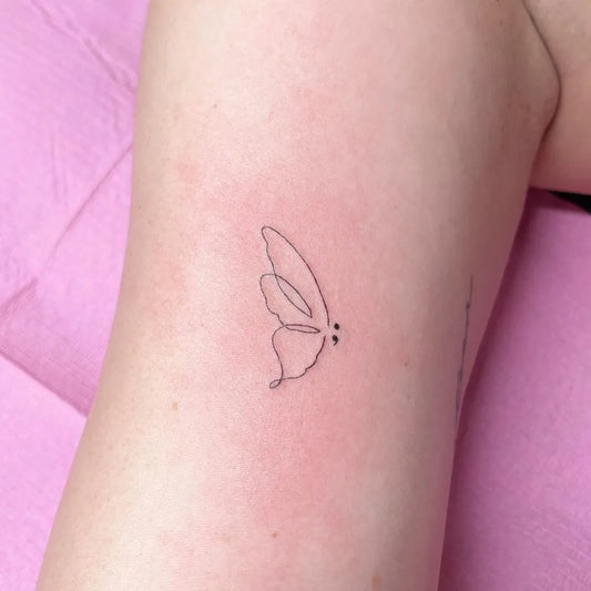 Tiny Linework Butterfly Semicolon on Women Thigh Tattoo by @pinkcosmetictattoo