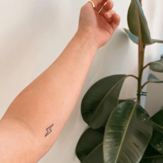 Tiny Linework Lightning Bolt Tattoo on Women Forearm by @emilyrosefisher