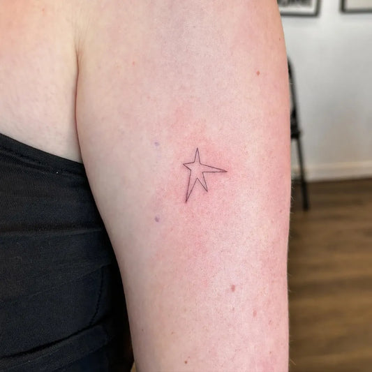 Tiny Linework Star Tattoo on Women UpperArm by @fineline.artistry