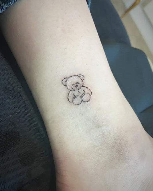 Tiny Linework Teddy Bear on Women Wrist Tattoo by @browsandbelles