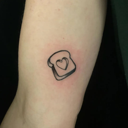 Tiny Linework Toast with Heart on Women Arm Tattoo by @ram_tattoo