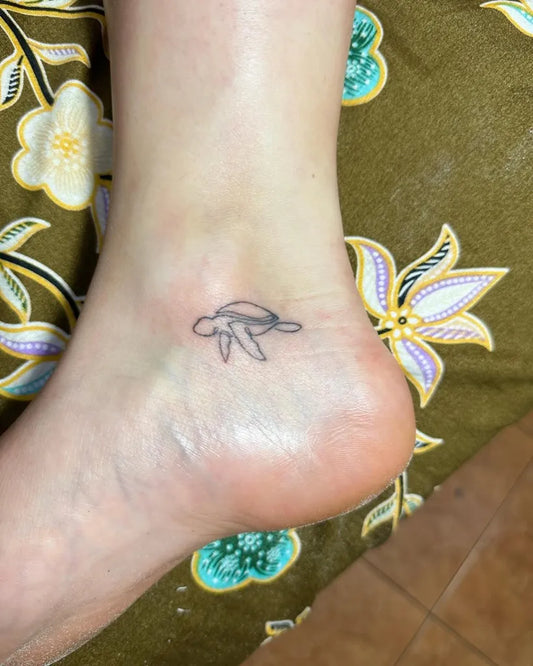 Tiny Linework Turtle Tattoo on Women Ankle by @imperial_bambootattoo