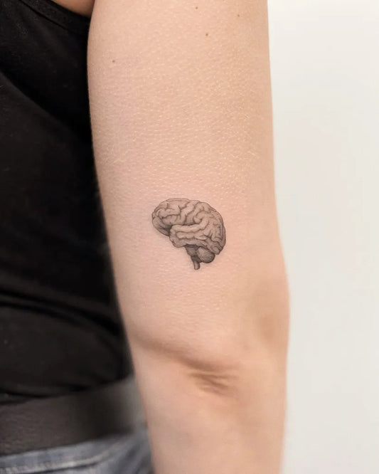 Tiny Micro Realism Brain on Women Upper Arm Tattoo by @domaradzka.ink