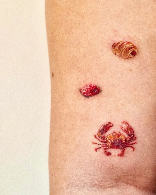 Tiny Micro Realism Eggs Crab on Women Arm Tattoo by @kektuztattoo