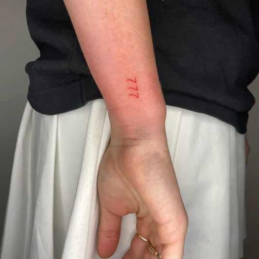 Tiny Minimalist 777 Tattoo on Women Wrist by @tatts.mo