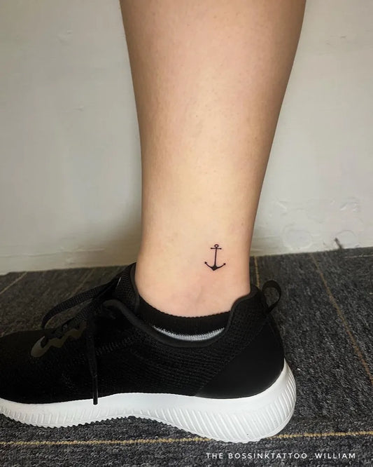 Tiny Minimalist Anchor Tattoo on Women Ankle by @thebossink.tattoo