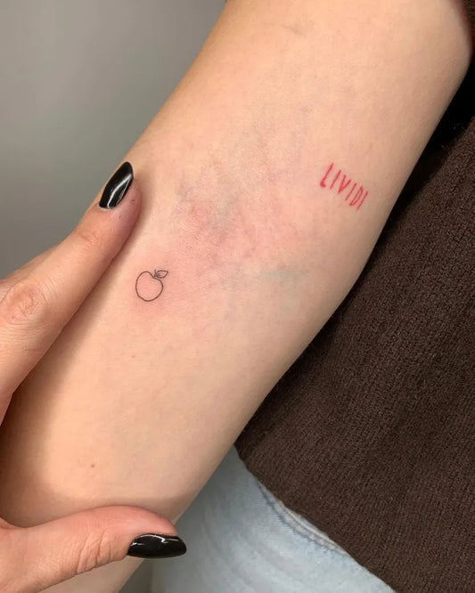 Tiny Minimalist Apple LIX on Women Arm Tattoo by @federica_mestici_tattooer