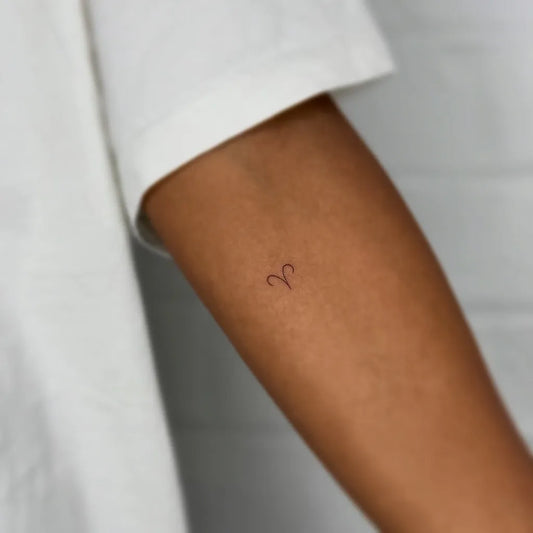 Tiny Minimalist Aries symbol on Women Arm Tattoo by @xenia_tats