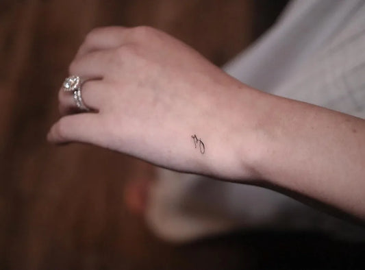 Tiny Minimalist Bird on Women Wrist Tattoo by @chad_bolo