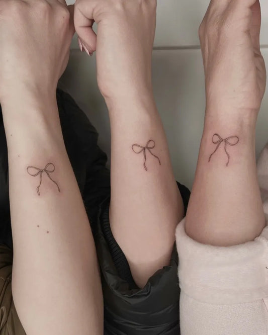 Tiny Minimalist Bow on Friends Wrist Matching Tattoo by @nicaartistry