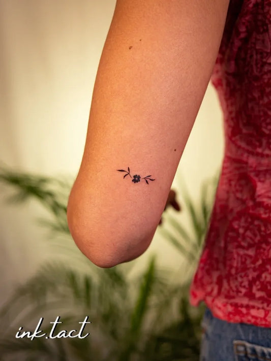 Tiny Minimalist Branch Leaf on Women Arm Tattoo by @ink.tact