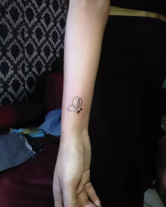 Tiny Minimalist Butterfly Semicolon on Women Arm Tattoo by @redlineink_tattoo_bandung