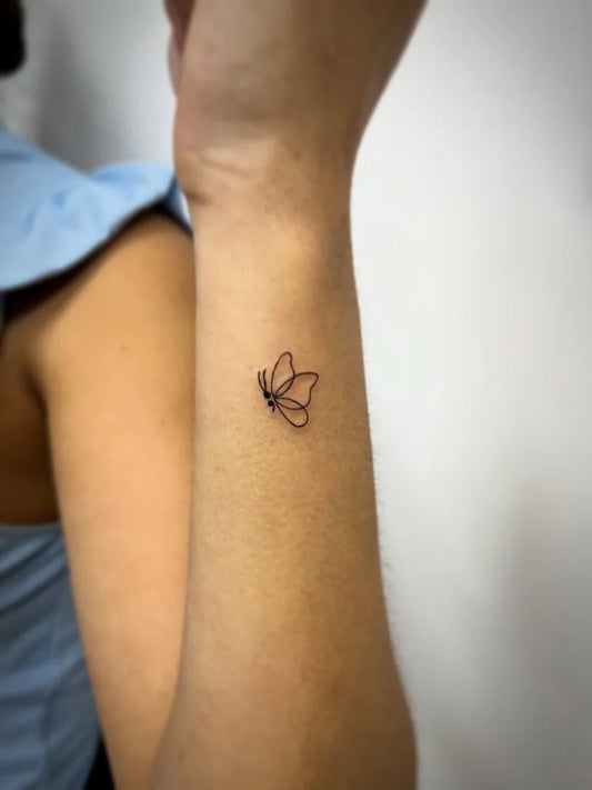 Tiny Minimalist Butterfly Semicolon on Women Wrist Tattoo by @tamara_pisano_dermo