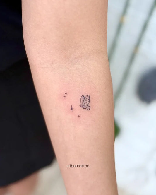 Tiny Minimalist Butterfly and Stars on Women Forearm Tattoo by @uribootattoo