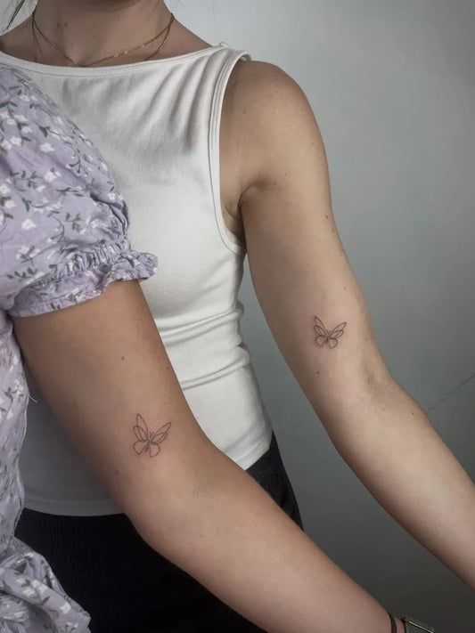Tiny Minimalist Butterfly on Friends Arm Matching Tattoo by @amis.ttt