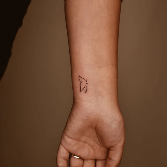 Tiny Minimalist Butterfly on Women Wrist Tattoo by @matt.vesta