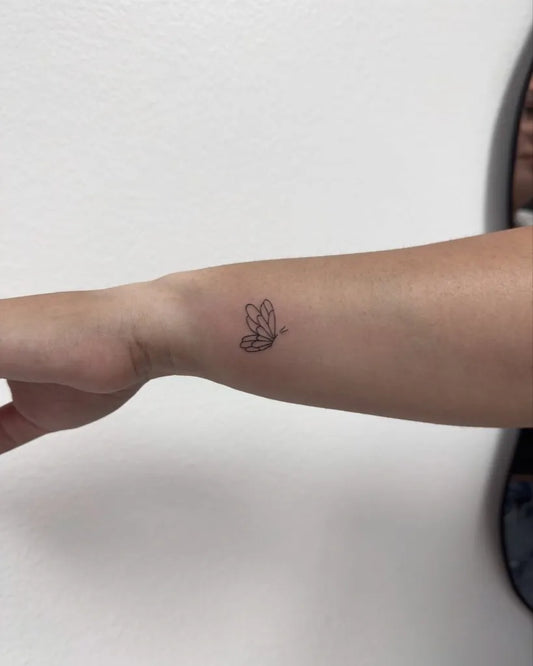 Tiny Minimalist Butterfly on Women Wrist Tattoo by @vanityink.bym