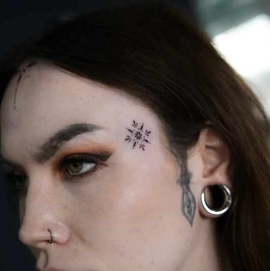 Tiny Minimalist Compass Rose on Women Face Tattoo by @kr.tattooer