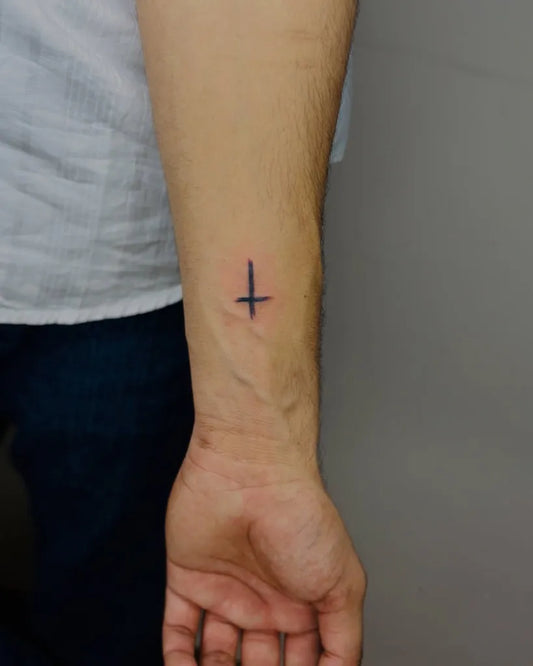 Tiny Minimalist Cross on Men Forearm Tattoo by @linecraft_tattoos