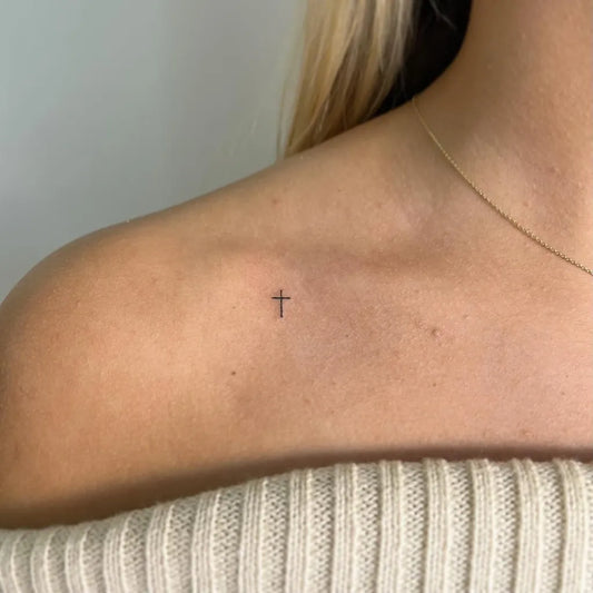 Tiny Minimalist Cross on Women Shoulder Tattoo by @bodymodfox
