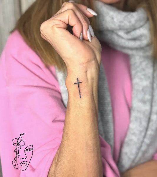 Tiny Minimalist Cross on Women Wrist Tattoo by @claudia86_ink
