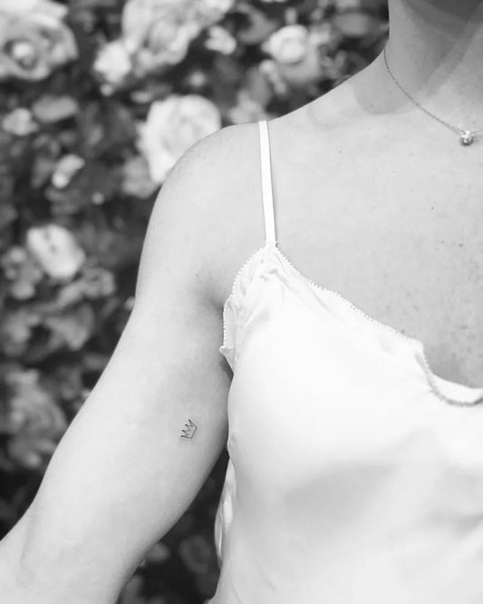 Tiny Minimalist Crown Tattoo on Women Arm by @tattoovasquez