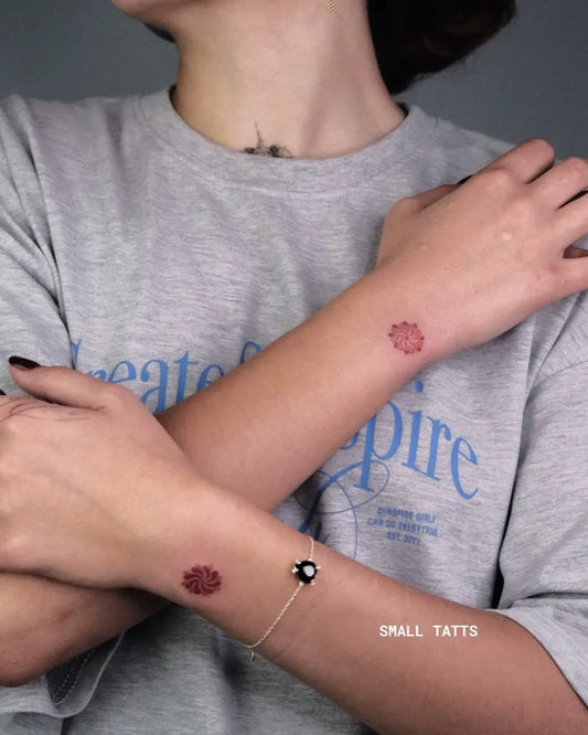 Tiny Minimalist Dahlia on Women Wrists Tattoo by @blackvibestattoo