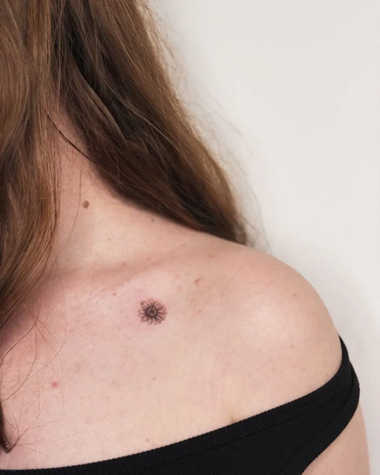 Tiny Minimalist Daisy Tattoo on Women Shoulder by @kayyang.tattoo