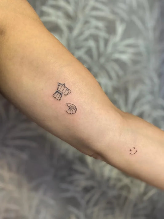 Tiny Minimalist Espresso Maker Croissant Smiley on Women Arm Tattoo by @allyxink