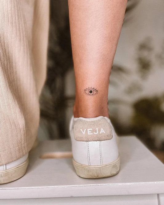 Tiny Minimalist Evil Eye on Women Ankle Tattoo by @phoebetattoos