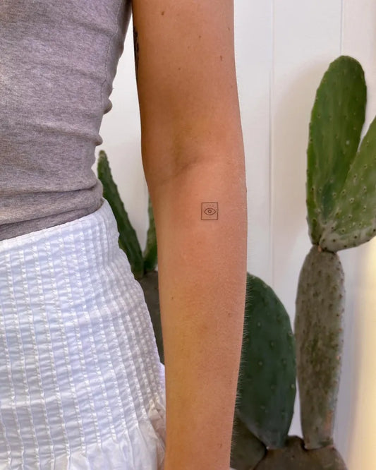 Tiny Minimalist Evil Eye on Women Arm Tattoo by @__elleink