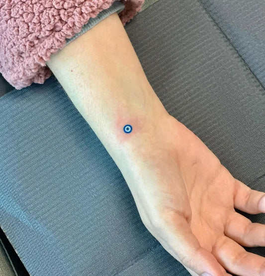Tiny Minimalist Evil Eye on Women Forearm Tattoo by @inkme.babyy