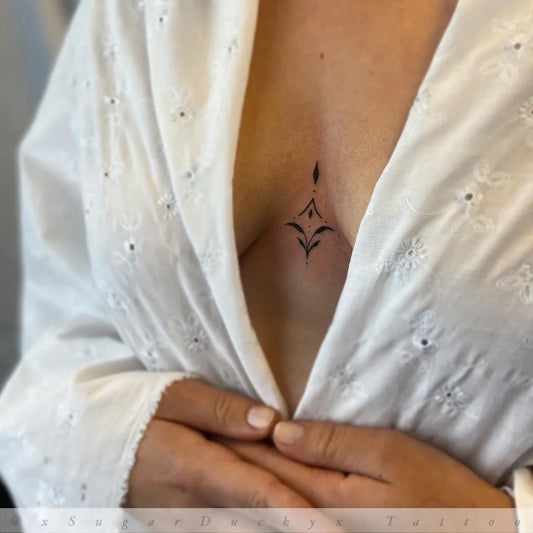 Tiny Minimalist Floral Flourish on Women Sternum Tattoo by @xsugarduckyx.tattoo