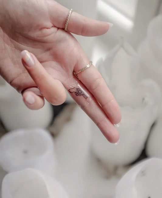 Tiny Minimalist Floral on Women Finger Tattoo by @tinytattooinc
