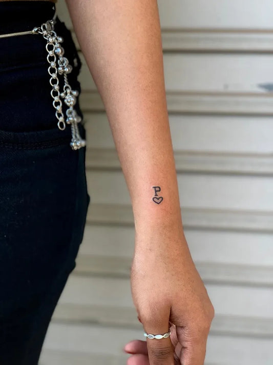 Tiny Minimalist Heart P on Women Wrist Tattoo by @khushi_tattoo2612