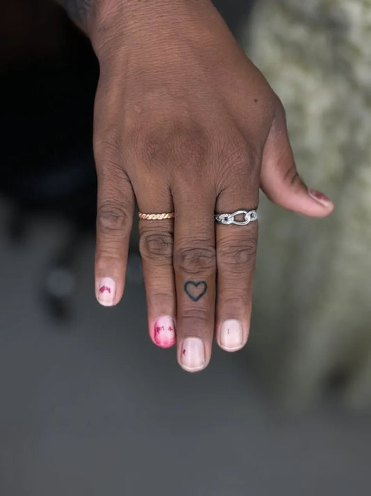 Tiny Minimalist Heart on Women Finger Tattoo by @kabirainktattooandpiercing
