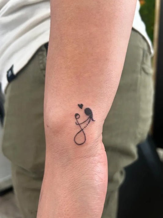 Tiny Minimalist Infinity Heart Bird on Women Wrist Tattoo by @inked.n.polished.byalex_