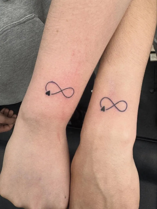 Tiny Minimalist Infinity Heart Tattoo on Women Arm by @tattoozbyeden