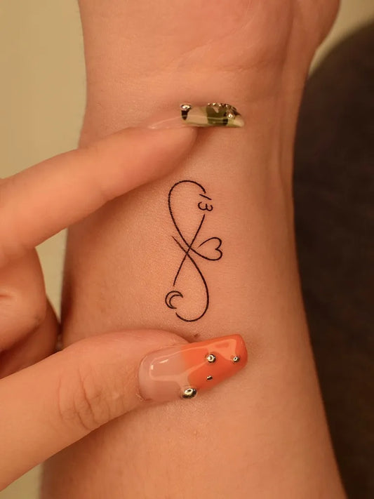 Tiny Minimalist Infinity Heart on Women Wrist Tattoo by @tattooer_jina